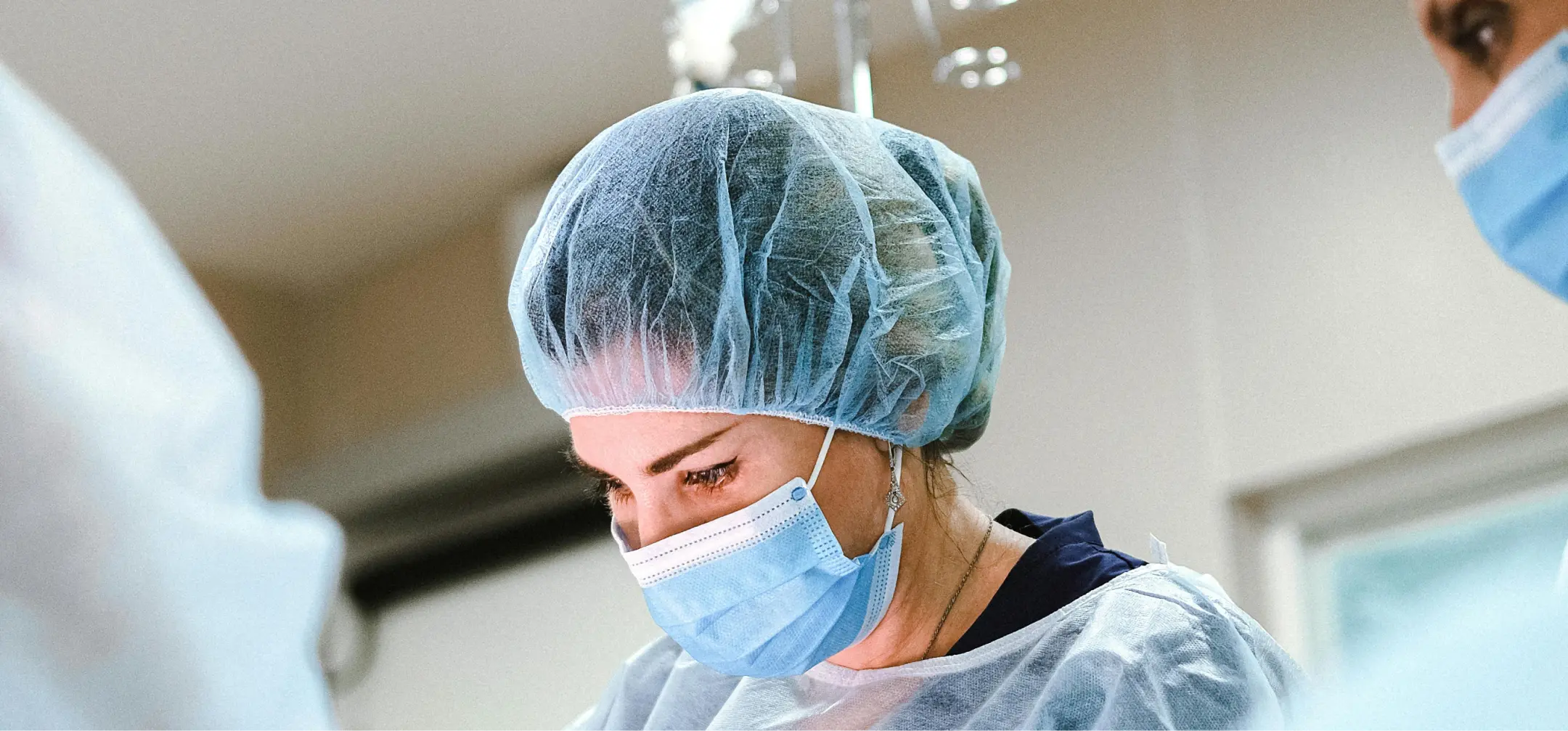 a woman wearing a surgical cap and mask