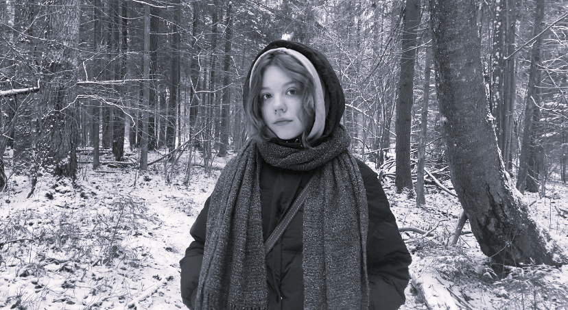 a woman in a scarf in a snowy forest