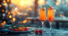 two glasses of orange liquid with fruit on a plate