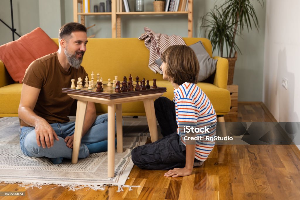 a man and boy playing chess
