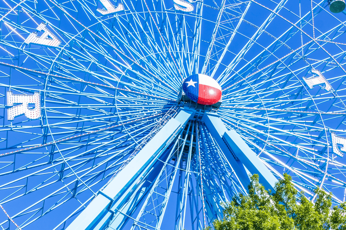 a ferris wheel with a flag on top