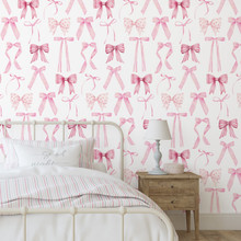 a bed with pink bows on wall