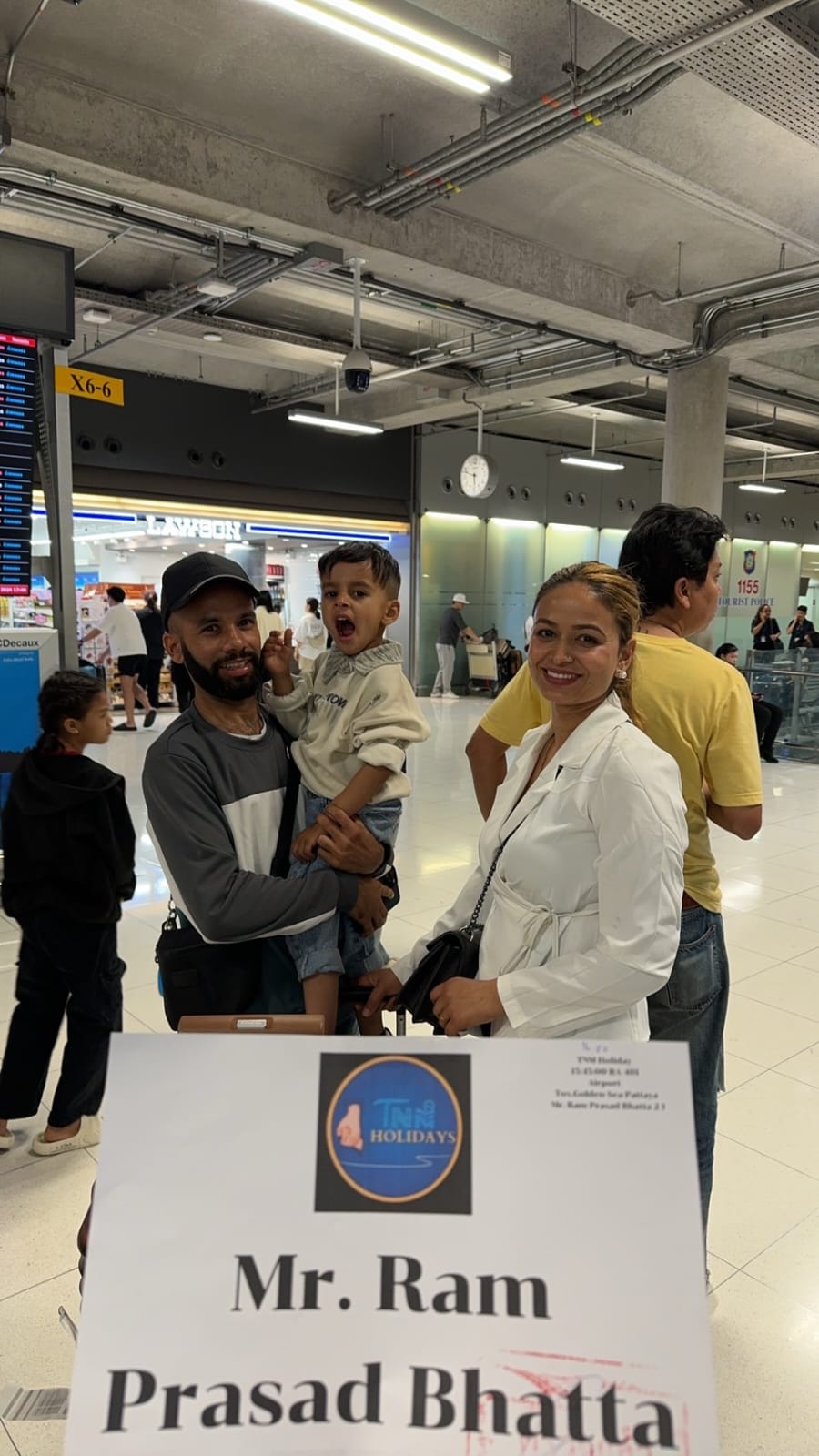 a man and woman with a child in a airport