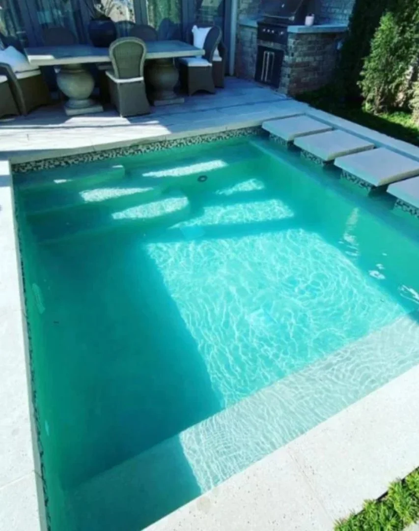 a pool with a table and chairs
