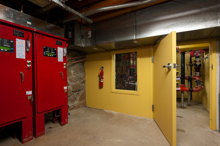 a yellow door with a red door and a red box