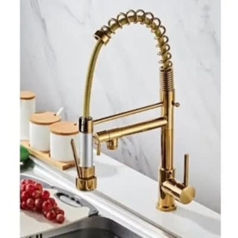 a gold faucet on a counter