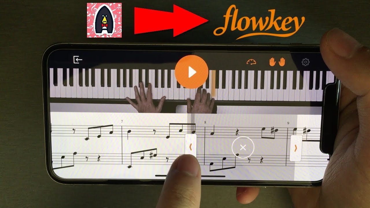 a hand playing piano on a smartphone