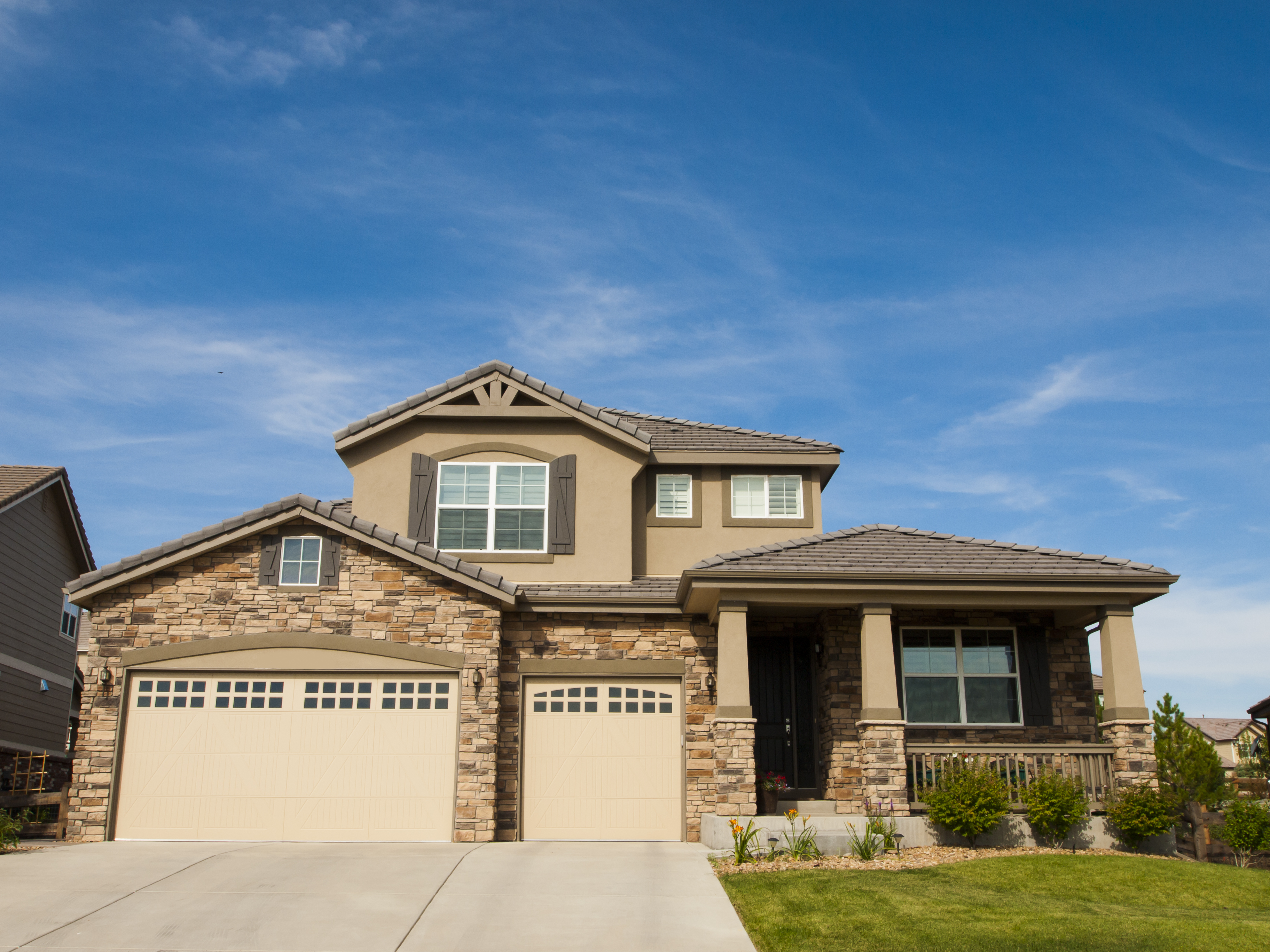 a house with a driveway and a lawn