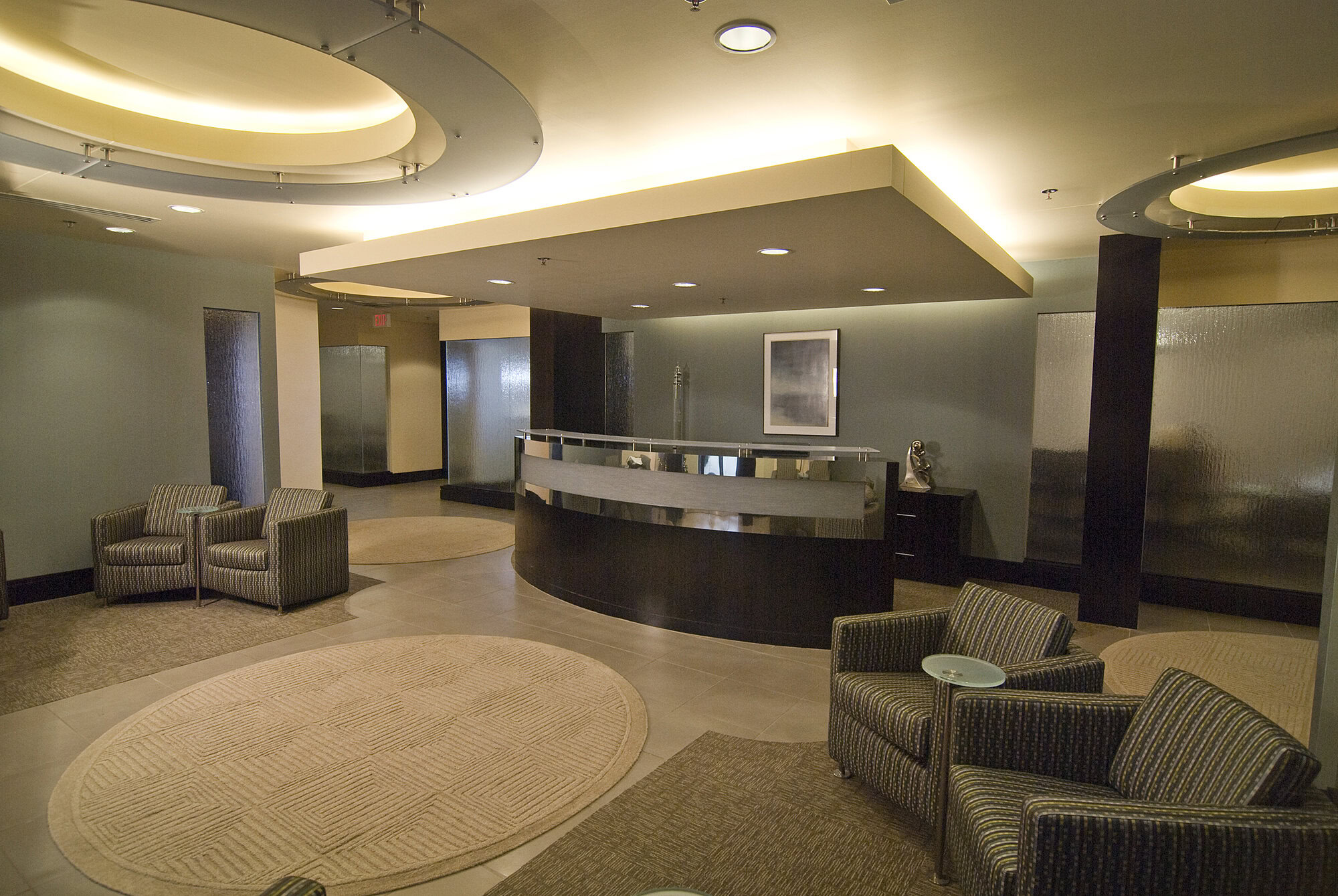 a lobby with a reception desk and chairs