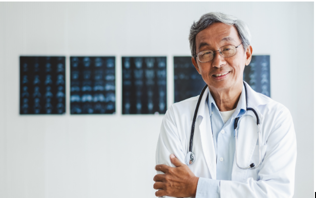 a doctor smiling with his arms crossed