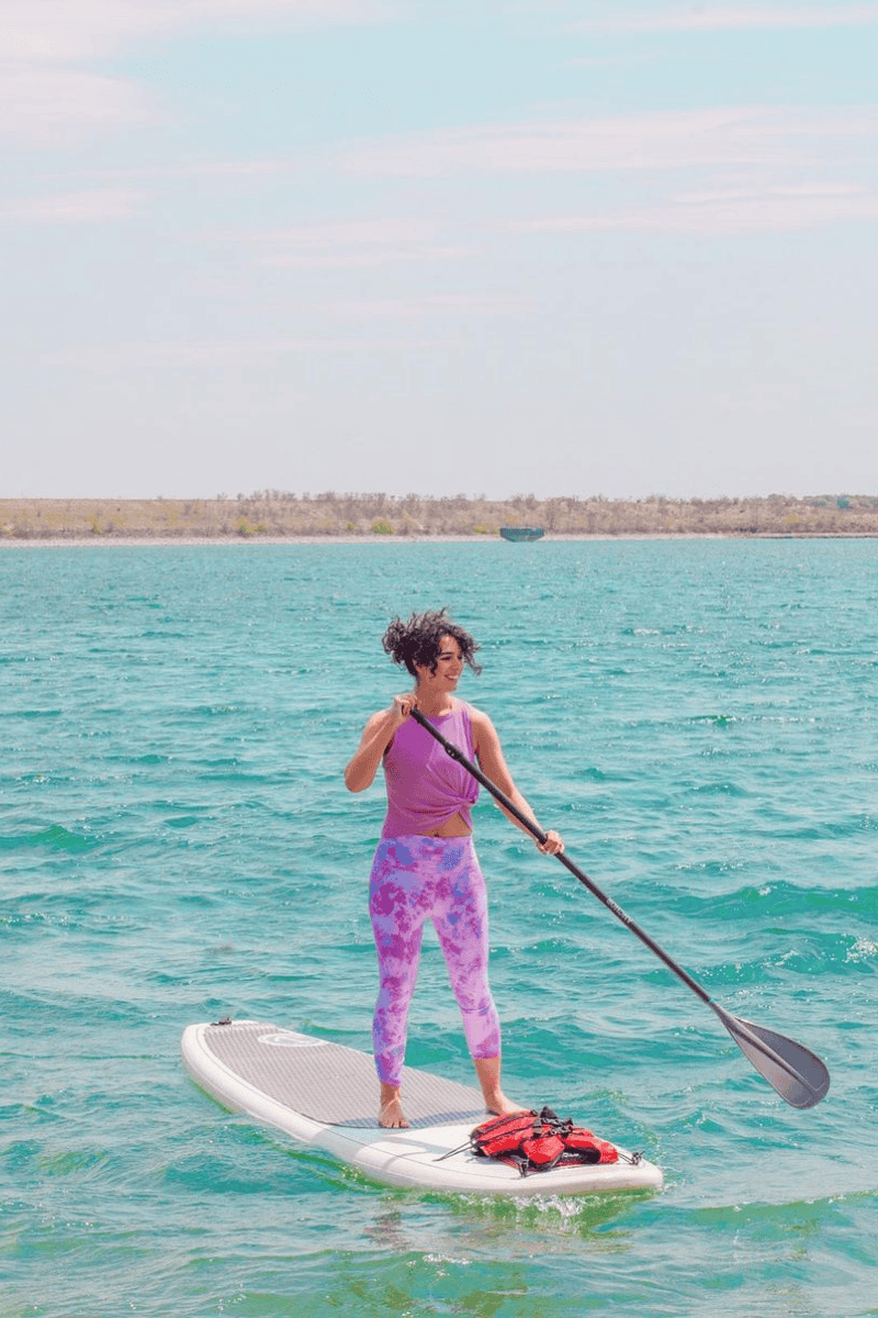 a woman on a paddle board