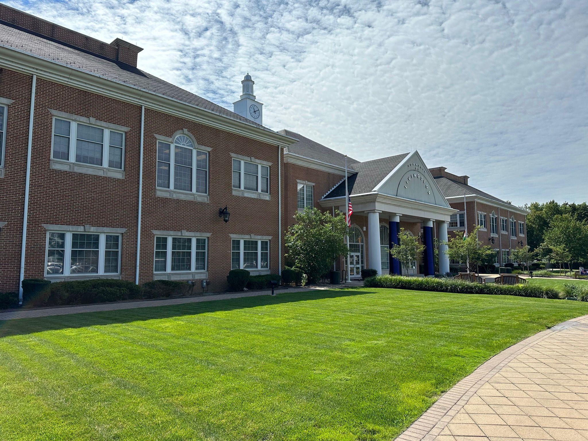 a building with columns and a lawn