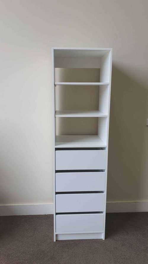 a white shelf with drawers