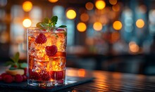 a glass of drink with ice and berries