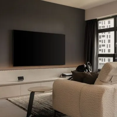 a living room with a television on the wall