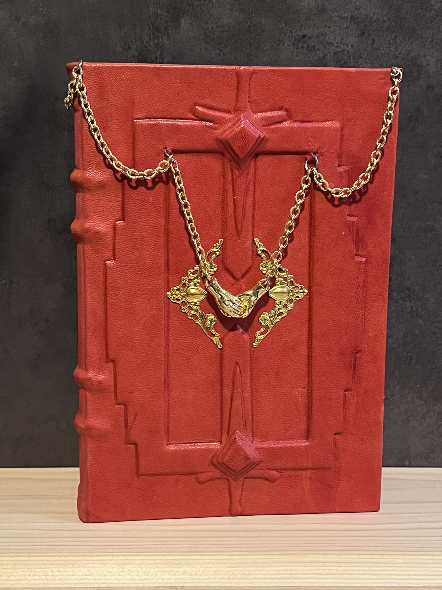 a red book with gold chains