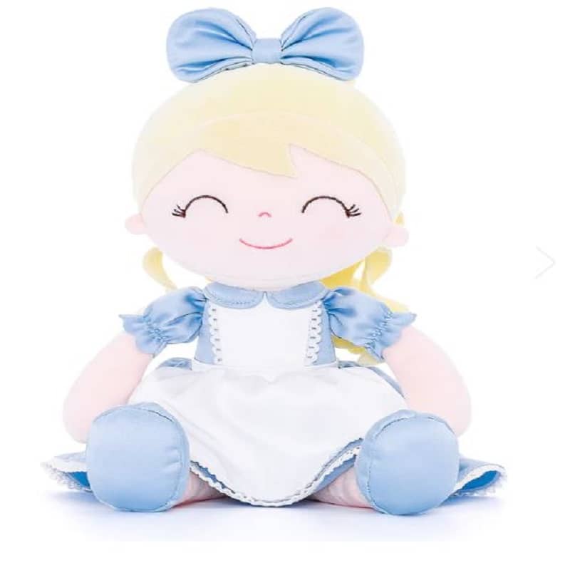 a stuffed toy girl in a dress