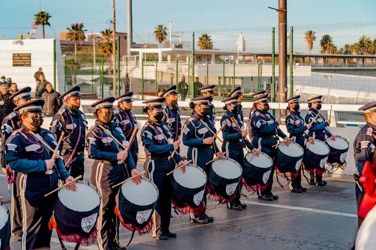 a group of people in uniform holding drums