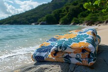 a blanket on a rock by the water