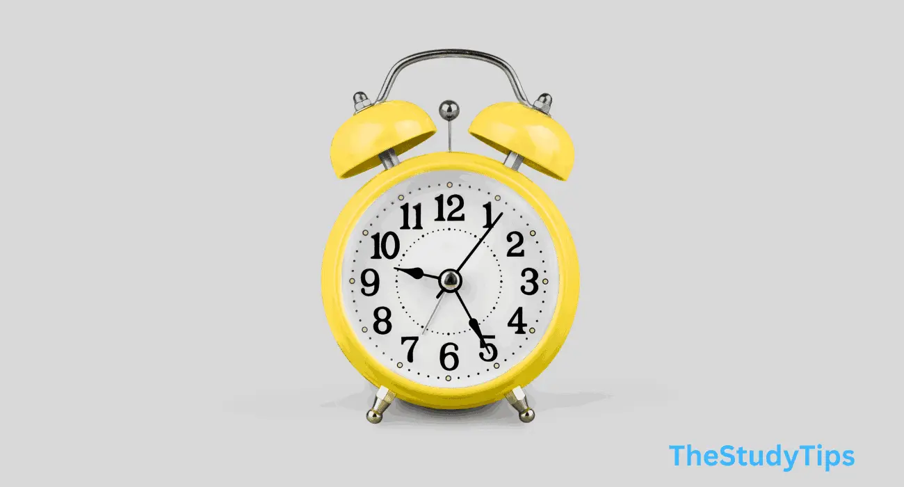 a yellow alarm clock with bells