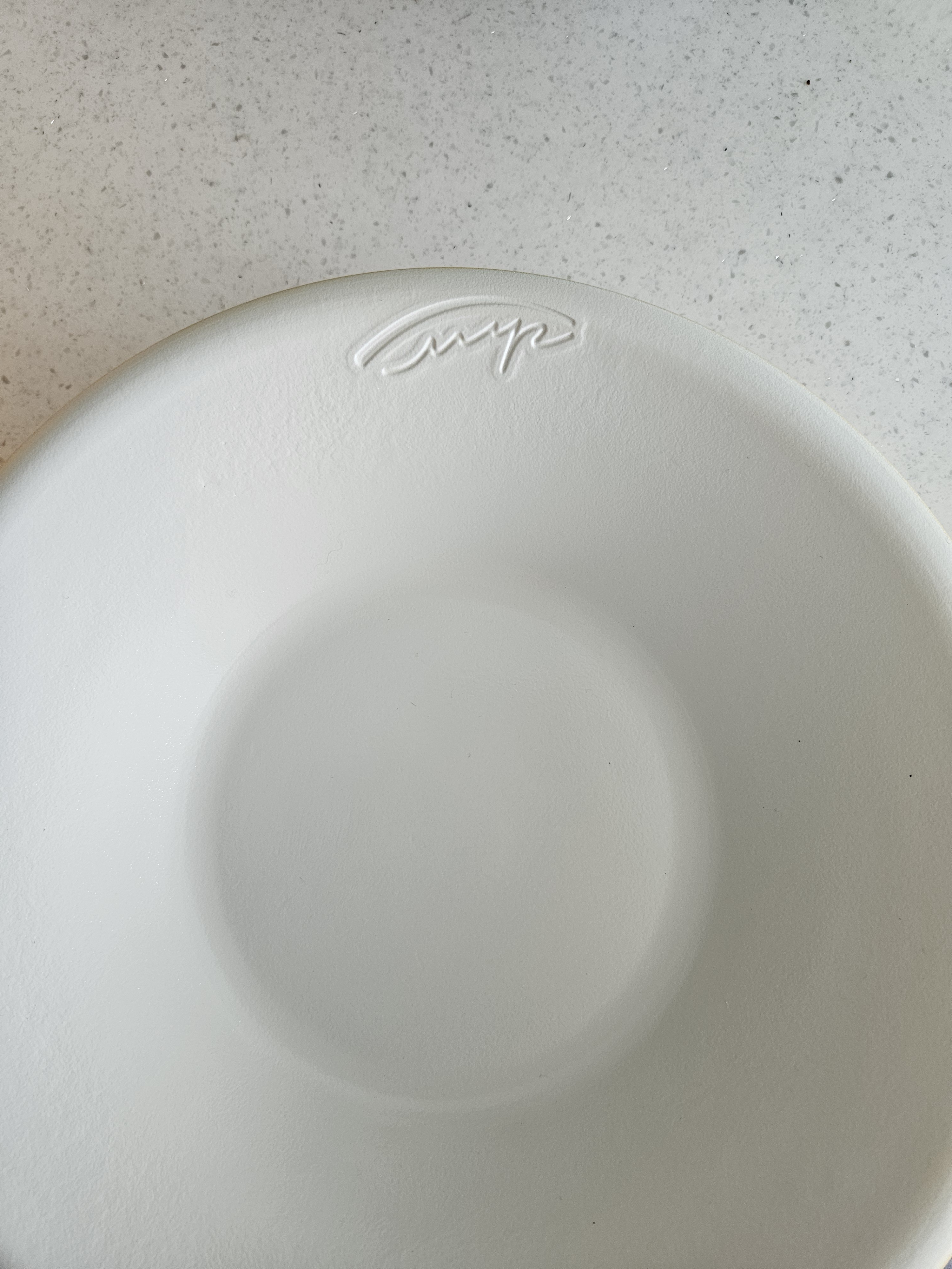 a white plate on a counter