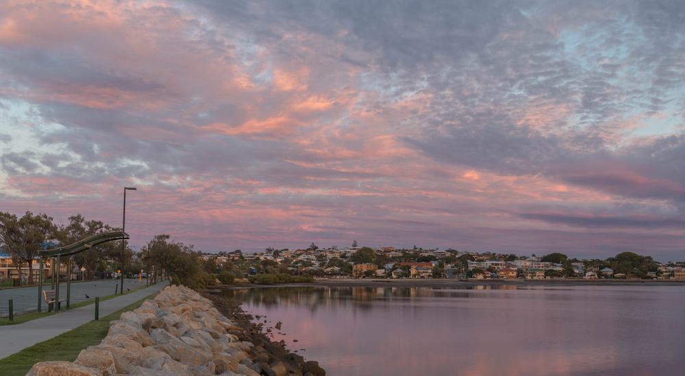 a body of water with a body of water and a city in the distance