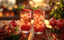 two glasses of red drink with fruit