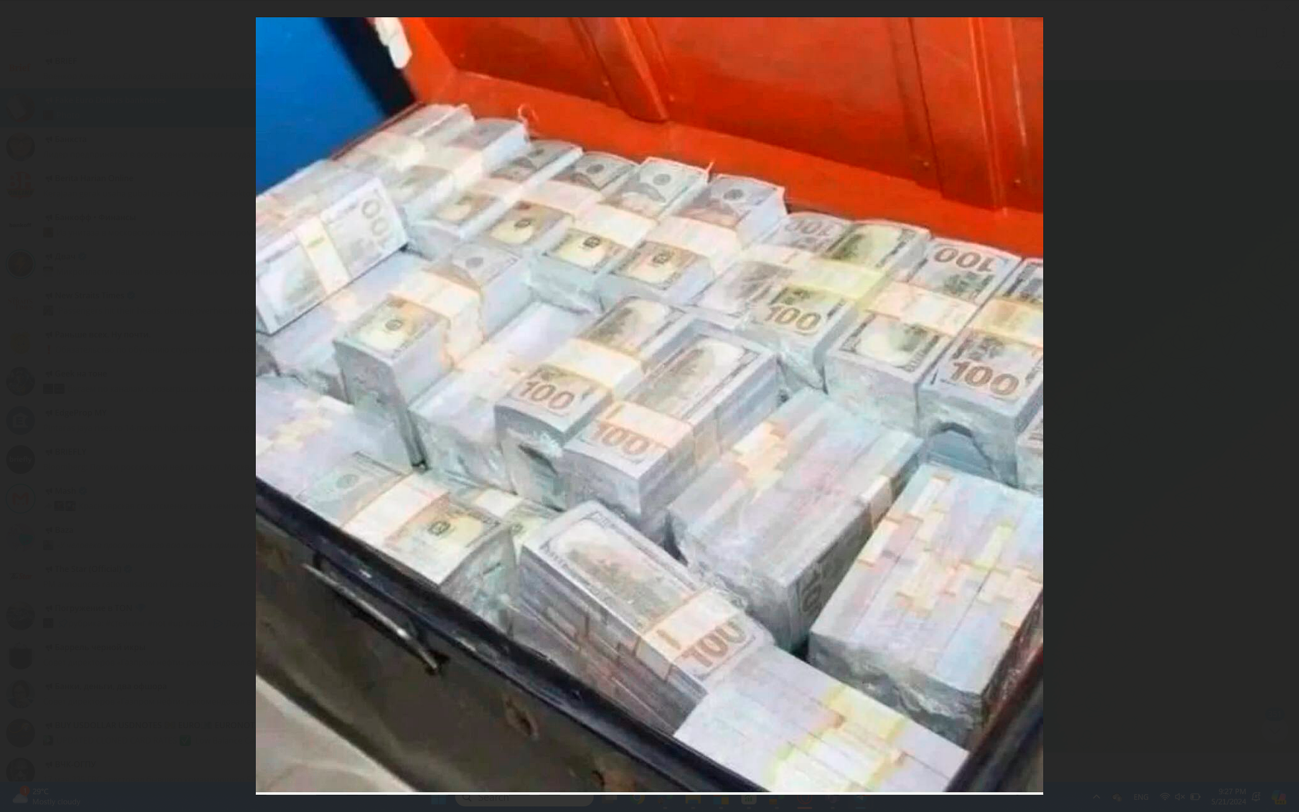 a large pile of money in a trunk