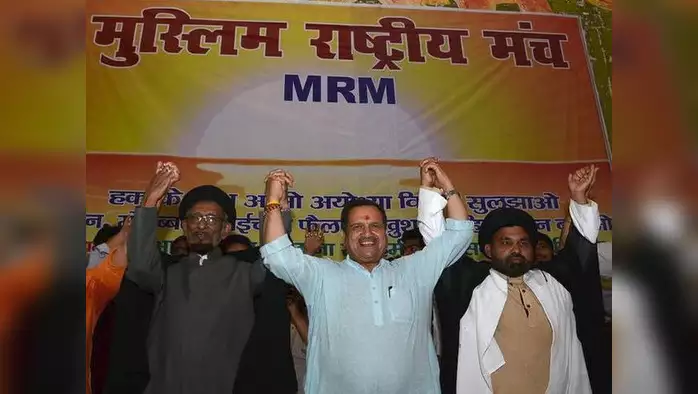 a group of men standing in front of a banner