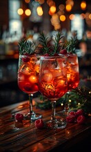 a group of glasses with red liquid and berries