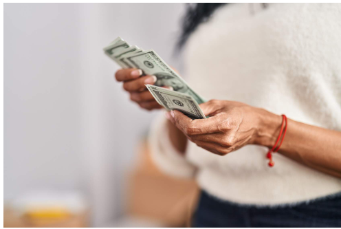 a woman holding money in her hands