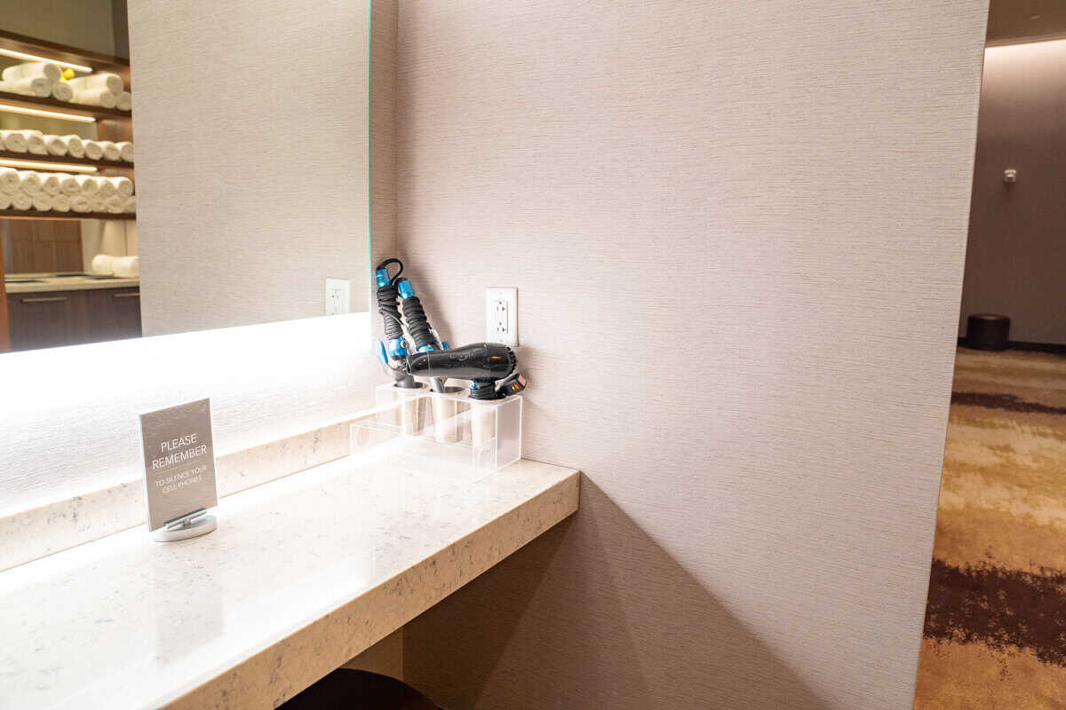 a hair dryer in a plastic container on a counter