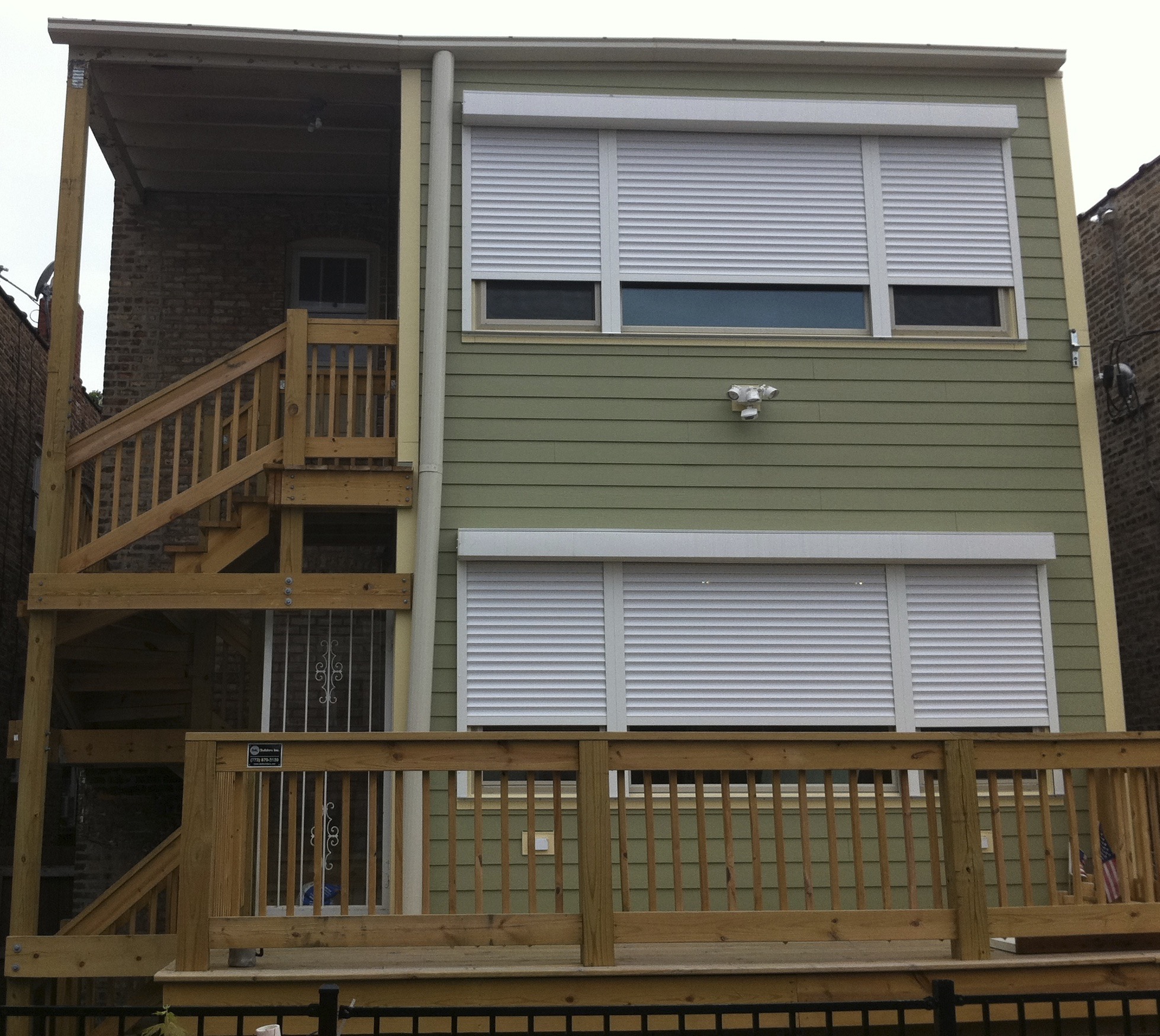 a building with a wooden deck and stairs