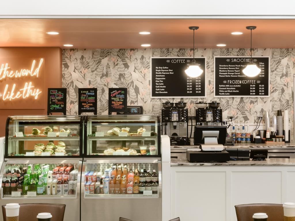 a coffee shop with a counter and shelves