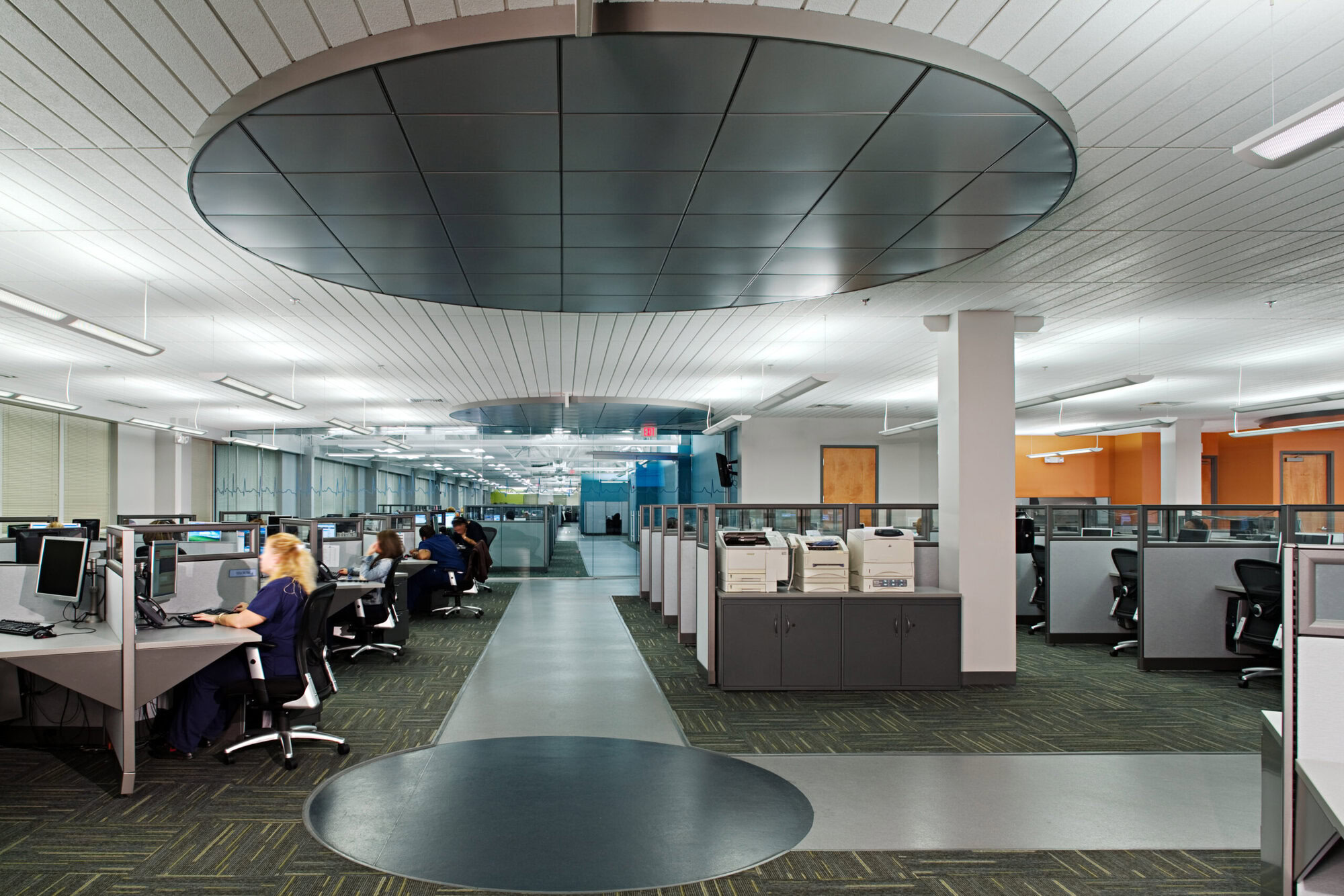 people sitting at desks in an office