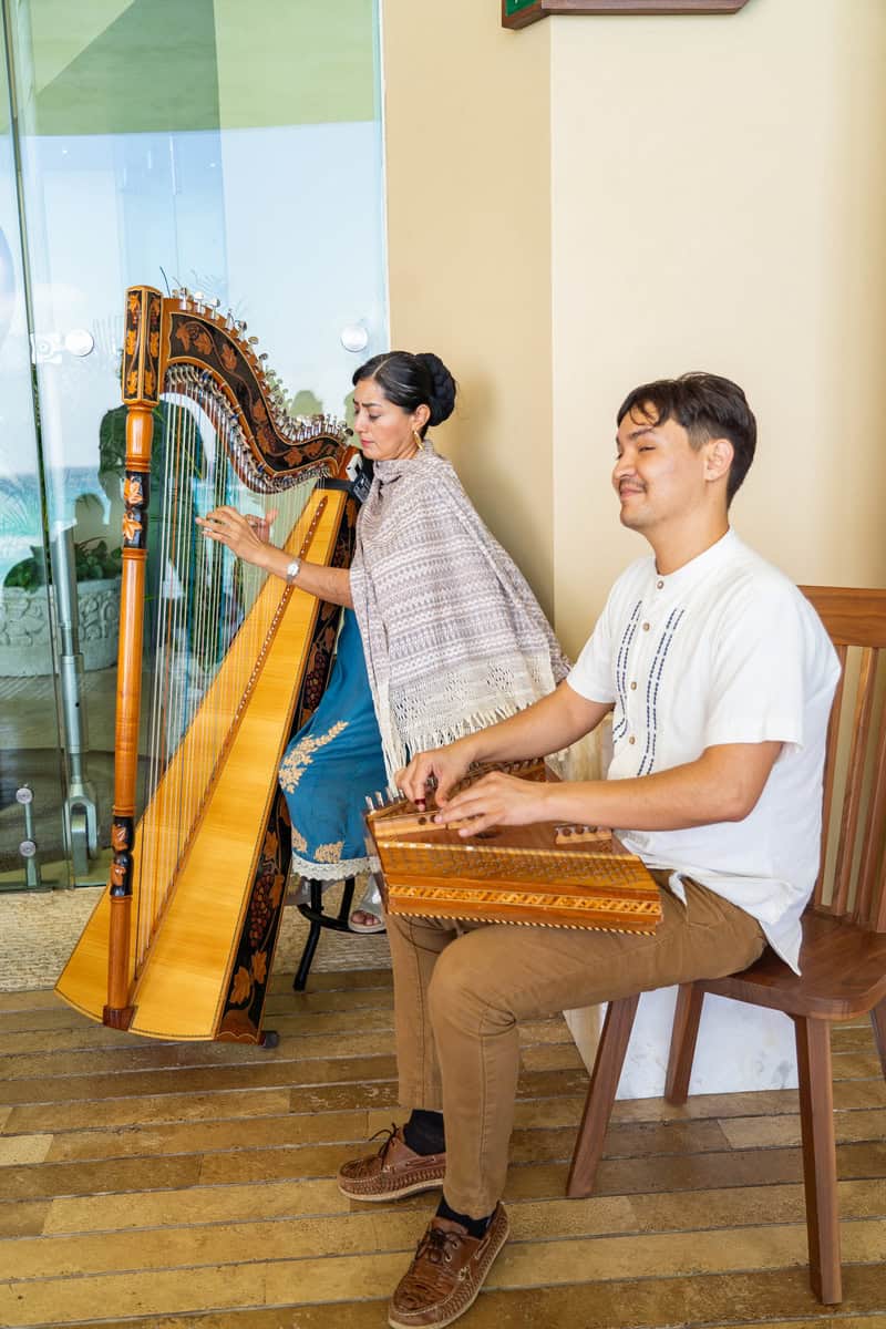 a man and woman playing harp