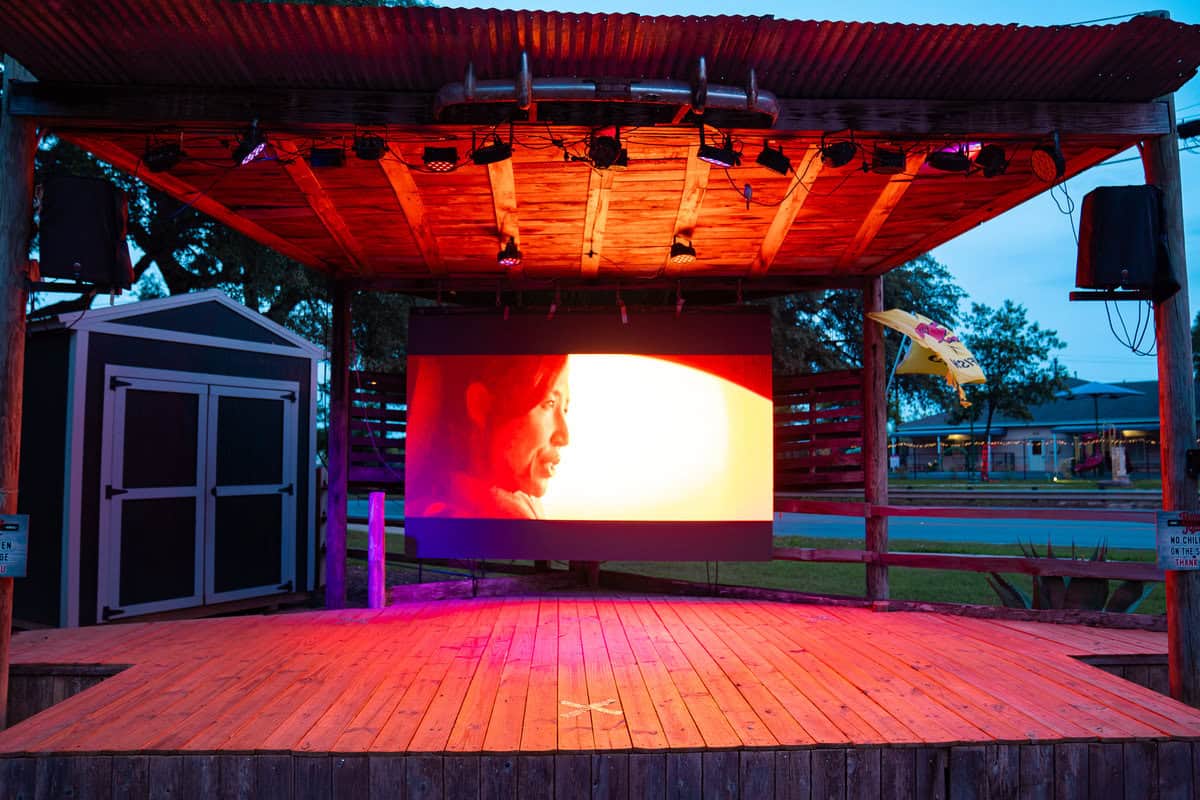 a stage with a screen and lights