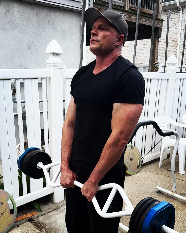 a man lifting weights outside
