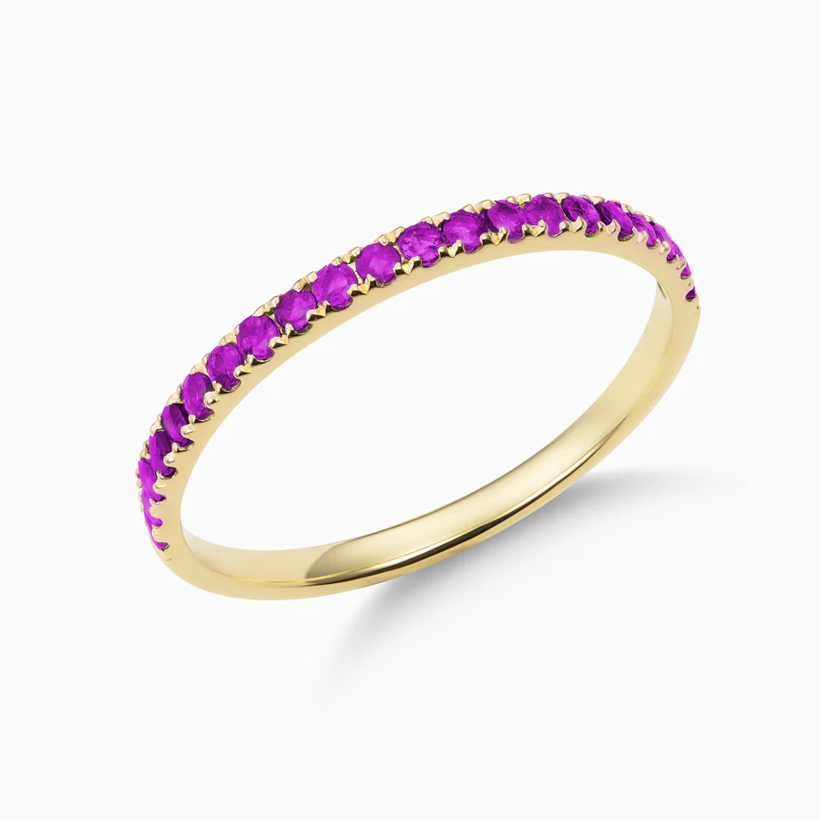 a gold ring with purple stones