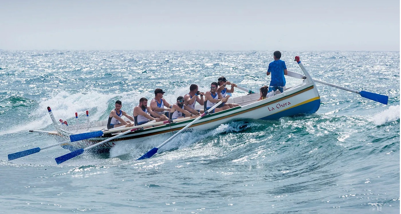 a group of people rowing a boat