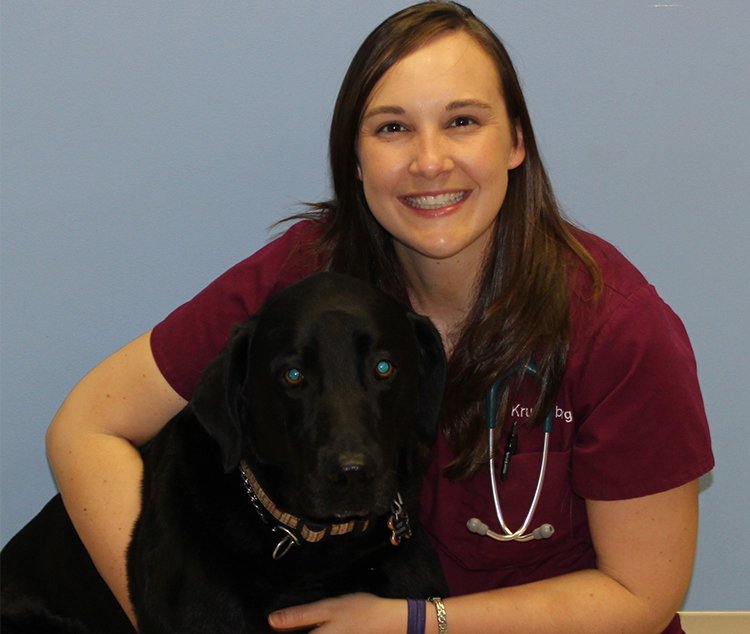 a woman with a stethoscope around her neck and a dog