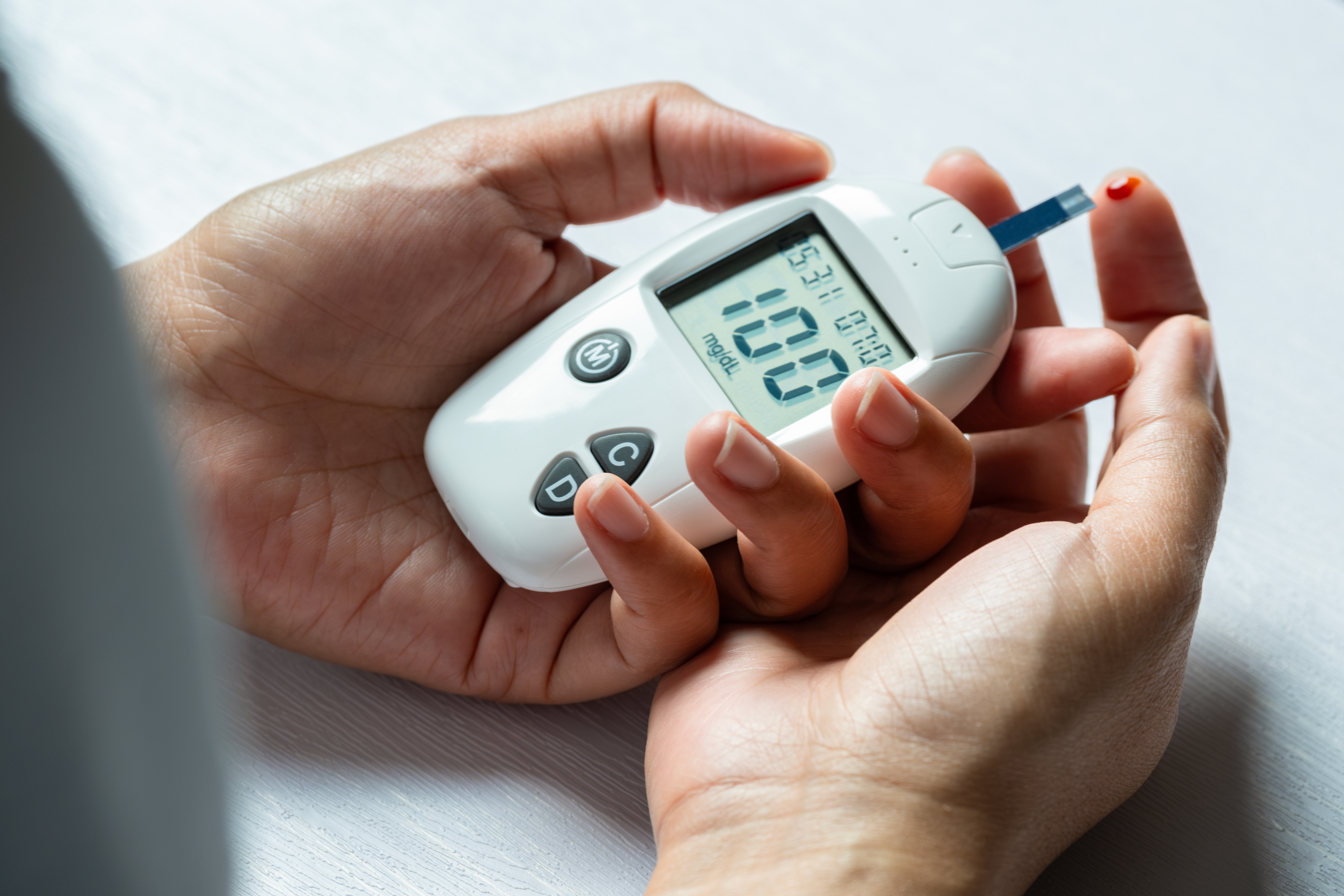 a person holding a device with a blood test