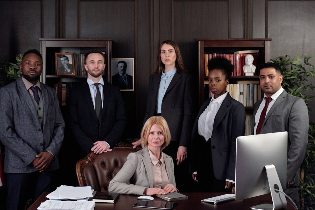 a group of people standing in an office