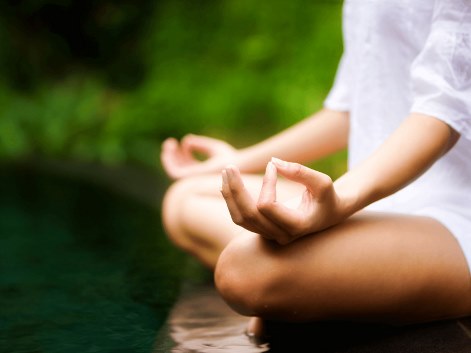 a person meditating in the water