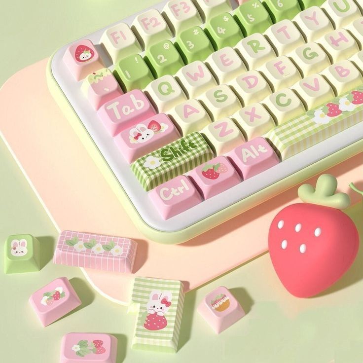 a keyboard and strawberry on a desk