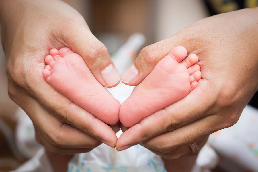 a baby feet in a person's hands
