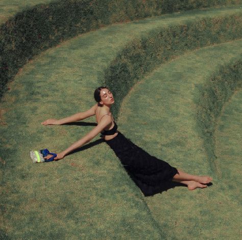 a woman lying on a grass field