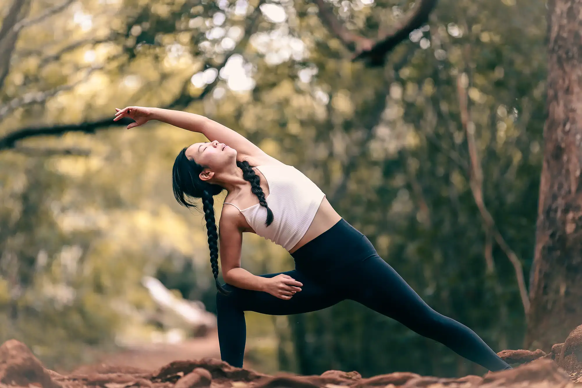 a woman stretching in the woods