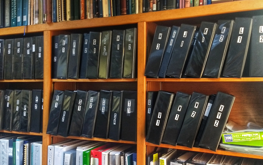 a shelf with binders on it