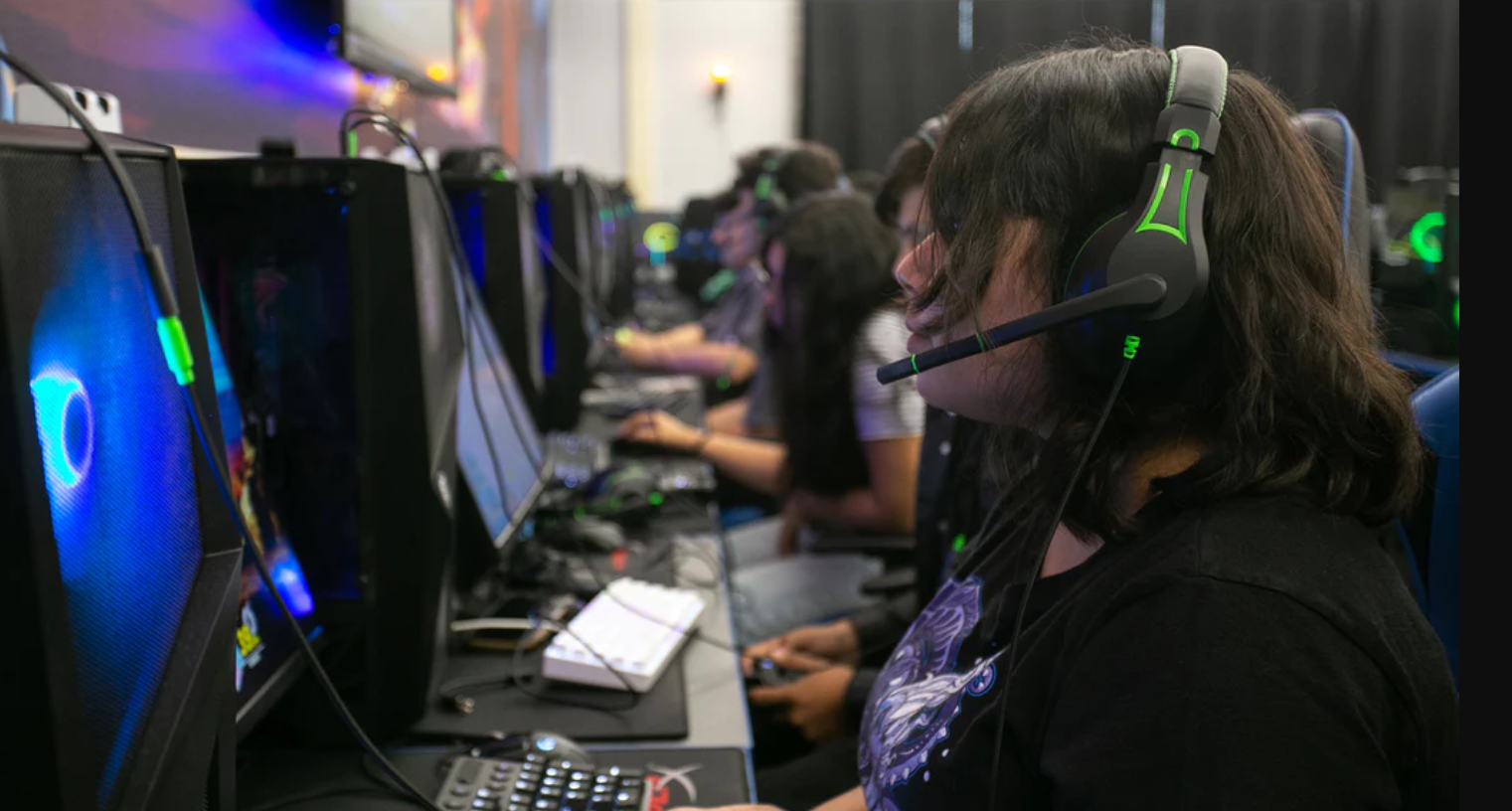 a group of people sitting in a row wearing headphones